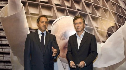 Daniel Scioli e Mauricio Macri con l’effigie papale sullo sfondo